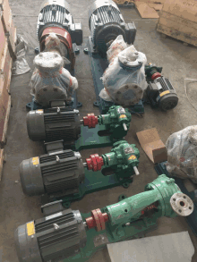 a bunch of different colored pumps and motors are lined up on the ground