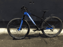 a black and blue bicycle with the word rocky on the front