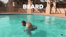 a man with a beard is swimming in a swimming pool