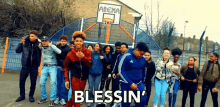 a group of young people are standing in front of a basketball court and the words blessin ' are on the bottom