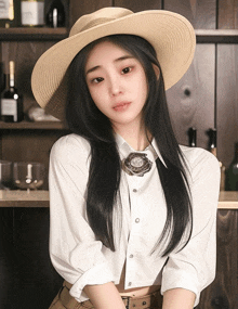 a woman wearing a hat and a white shirt with a flower brooch