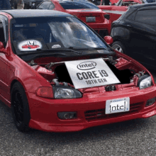 a red car with the hood open has an intel core i9 10th gen sign on the hood