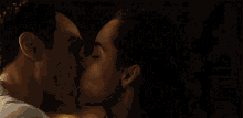 a man and a woman kissing in the dark