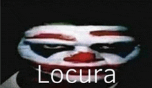 a close up of a clown 's face with the word locura in white letters .