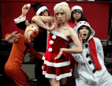 a group of people dressed in christmas costumes including a snowman