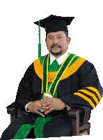 a man in a graduation cap and gown with a ring on his finger