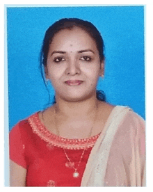 a woman wearing a red top and a gold necklace poses for a picture