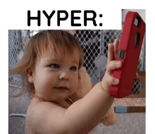 a baby is holding a red cell phone with the word hyper written above it