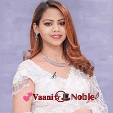 a woman in a white dress with the words vaani noble written below her