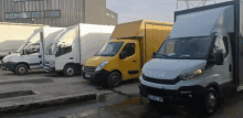 a white iveco van is parked next to a yellow van