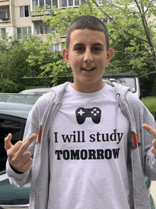 a young man wearing a t-shirt that says i will study tomorrow