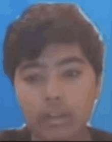 a close up of a person 's face on a blue background .