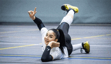 a woman laying on the floor with her arms outstretched and the letter y on her arm