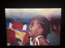 a picture of a little girl crying with her mouth open