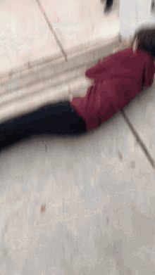 a person in a red shirt is laying on the ground