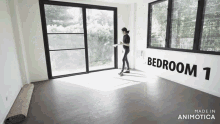 a woman is standing in an empty bedroom with the word bedroom 1 on the wall