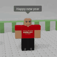 a man wearing a red shirt that says happy birthday roblox 12 years is standing on a tiled floor .