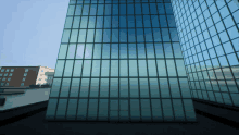 a tall building with a lot of windows and a blue sky behind it