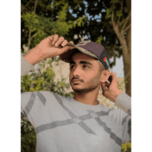 a young man wearing a hat that says ' nc ' on it