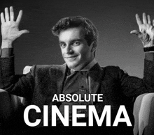 a black and white photo of a man with his hands in the air and the words absolute cinema above him