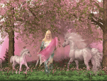 a woman is standing next to two unicorns in a field of pink flowers