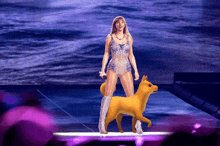 a woman in a leotard is standing next to a dog