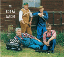 a group of men standing in front of a wooden building with vi bor på landet written on the top