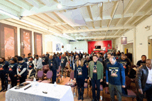 a group of people are standing in a room wearing black shirts that say ' freedom ' on them