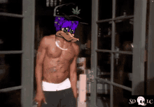 a shirtless man with a duck on his head is standing in front of a door