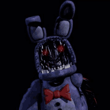 bonnie the bunny from five nights at freddy 's with a red bow tie and red eyes .