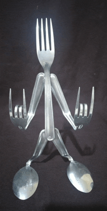 a person made out of forks spoons and knives making a rock sign