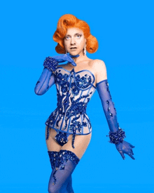 a woman with red hair wearing a blue corset and gloves