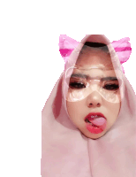 a woman wearing a pink hijab and glasses sticks her tongue out