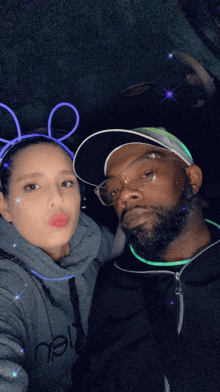 a man and a woman wearing glow in the dark headbands