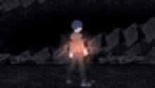 a blurry image of a person standing in the dark with a red light coming out of their chest .