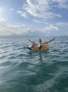 a man is floating in the ocean on a yellow raft that says ' float ' on it