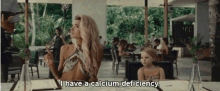 a woman says i have a calcium deficiency while sitting at a table with a little girl