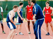 a group of athletes on a track with one wearing a red tank top that says ' army ' on it