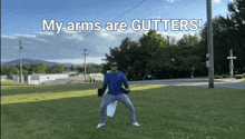 a man in a blue shirt is holding a frisbee in a field with the words my arms are gutters