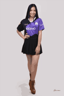 a girl wearing a purple and black echo jersey