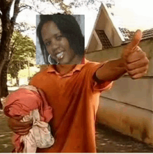 a man in an orange shirt is giving a thumbs up with a picture of a woman on his face .