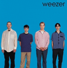 four men standing in front of a blue background with weezer written on the bottom