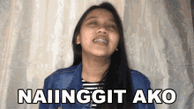 a woman with braces on her teeth is making a funny face and says naiinggit ako