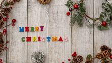 christmas decorations on a wooden surface with the words merry christmas