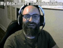 a man with a beard and glasses wearing headphones with the caption my reaction to that information