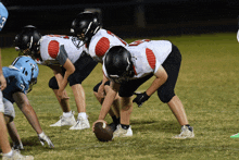 a group of football players are lined up on the field and one of them has the number 23 on their helmet