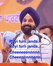 a man in a turban speaking into a microphone with the words " royi turii jada " above him