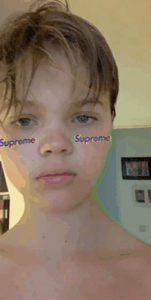 a young boy with supreme on his face