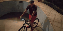 a man wearing sunglasses and a hat is riding a bicycle