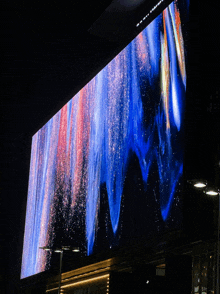 a large screen displays a blue and red graphic